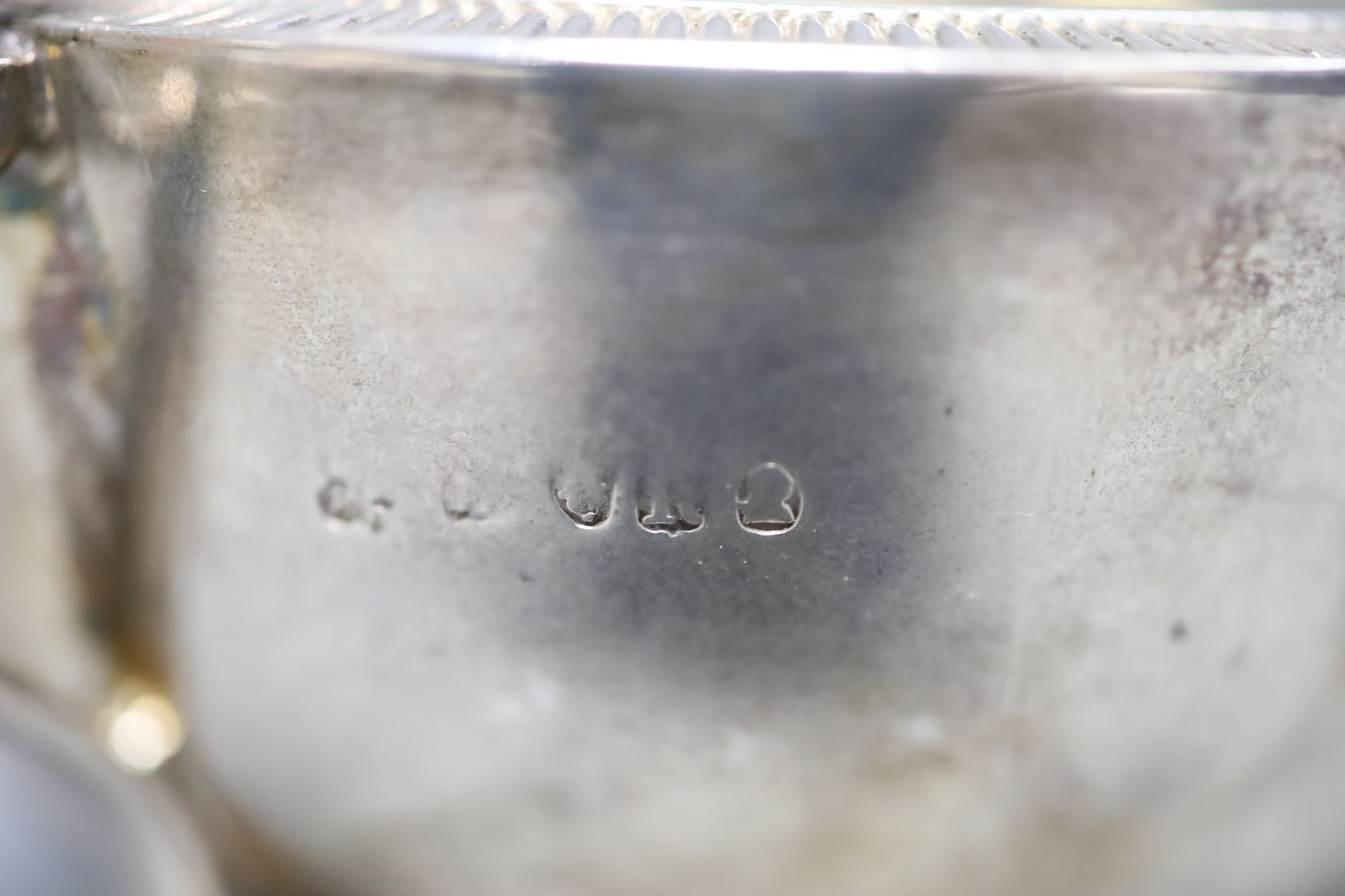 A George III silver milk jug, with milled border and engraved crest,, Eames & Barnard, London, 1812, height 87mm, 5oz.